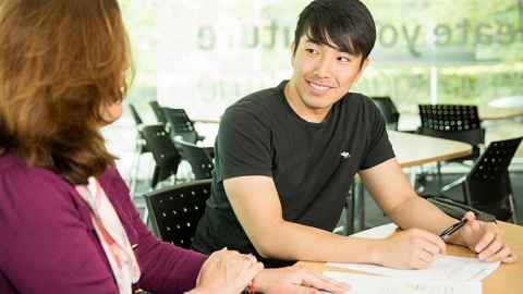Student talking with a learning adviser