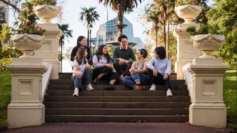 students sitting on steps in Albert Park 