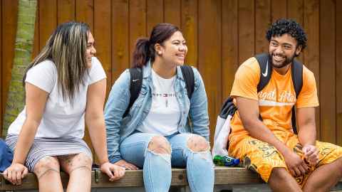 student sitting chatting to each other on campus