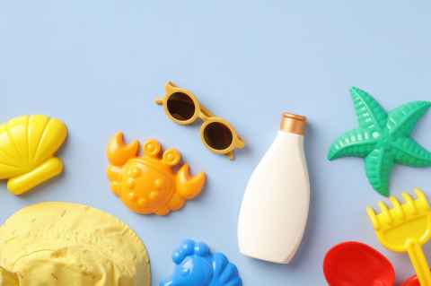 sunglasses, sunscreen, starfish and sand toys