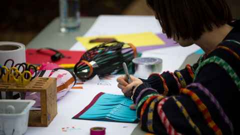 Person colouring a lantern.