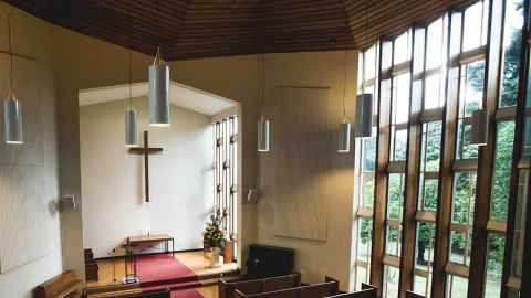 View from inside the chapel, with sunlight streaming in the windows.