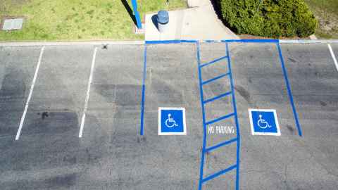 An empty parking lot with two accessible parking spaces