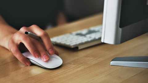 Image of a person clicking a computer mouse.
