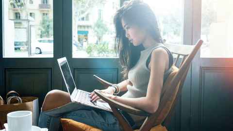 Lady using laptop in a coffee shop 