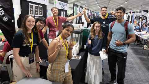 A group of seven students posing for a photo at Clubs Expo