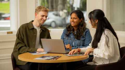 Trio of international students working together at a round table