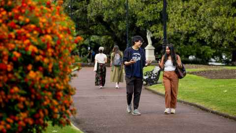 Two international students walking and chatting