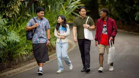 Four international students walking and chatting