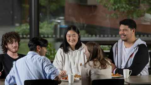 Students chatting at a dining table
