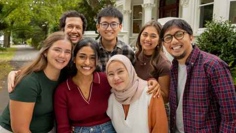 Seven smiling students looking into the camera