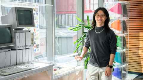 Smiling man standing in a museum of computing