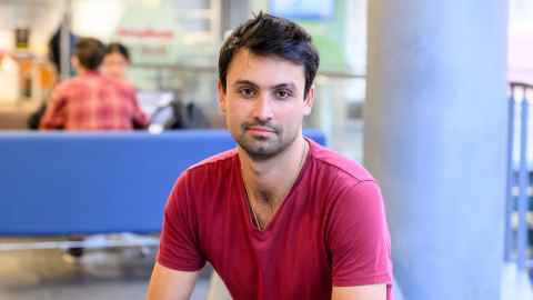 Man sitting indoors in a modern area
