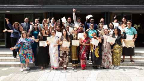 Group of Manaaki scholars celebrating outdoors, dressed in traditional costumes