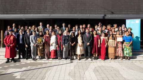 Group of Manaaki scholars celebrating outdoors, dressed in traditional costumes
