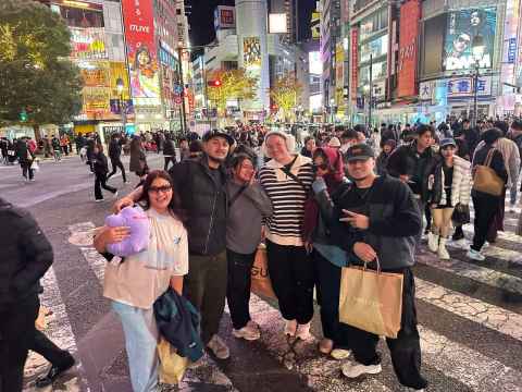 Students posing for a picture in Japan during night
