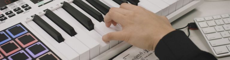 Student playing music on keyboard, used as a header banner image for Bachelor of Arts/Bachelor of Music conjoint.