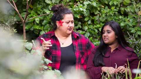 Two women amongst trees