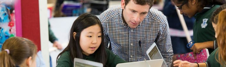 Teacher helping student in the classroom