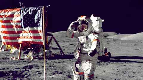 Astronaut saluting the American flag on the moon