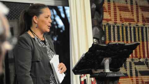 Woman speaking behind lectern 