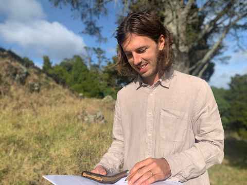 Daniel standing outdoors and smiling