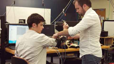 Dr Andrew McDaid and a postgraduate student testing a robotics rehabilitation device.