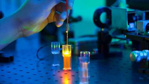 A person working with electronics in a lab.