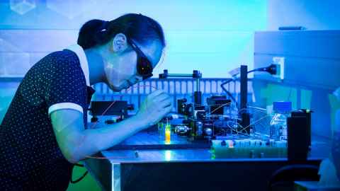 Woman working in photonics laboratory