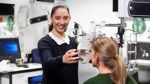 A woman administering an eye test.