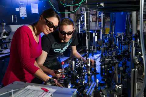 Two people working in a photonics laboratory 