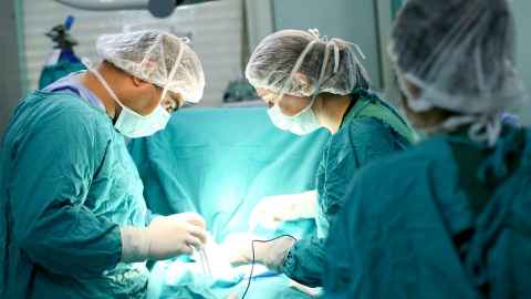Two surgeons operating on a patient.