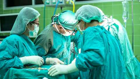 Surgeons at work in an operating theatre.