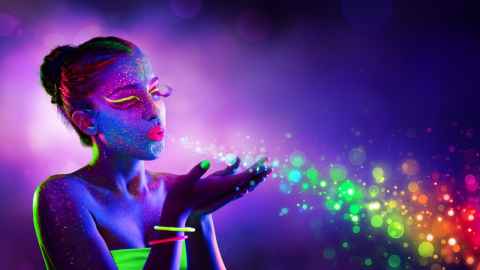 Brightly coloured image of woman blowing bubbles