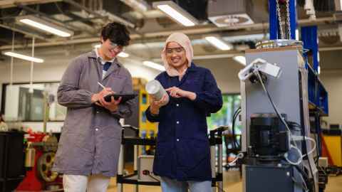 Two people in an engineering workshop