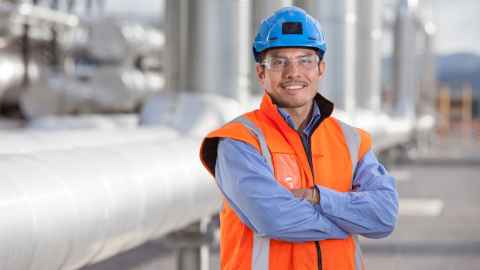 Engineer standing in front of engineering site