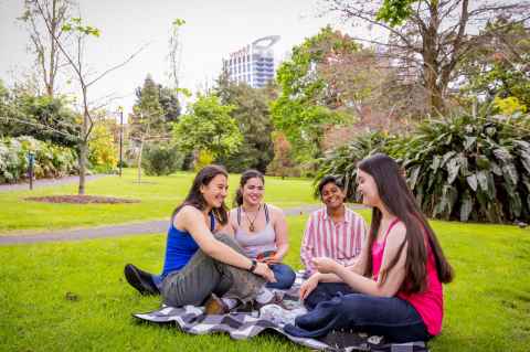 Summer Start students on lawn in University of Auckland gardens
