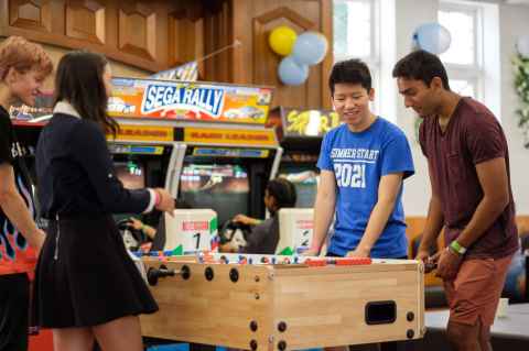 Students playing table soccer