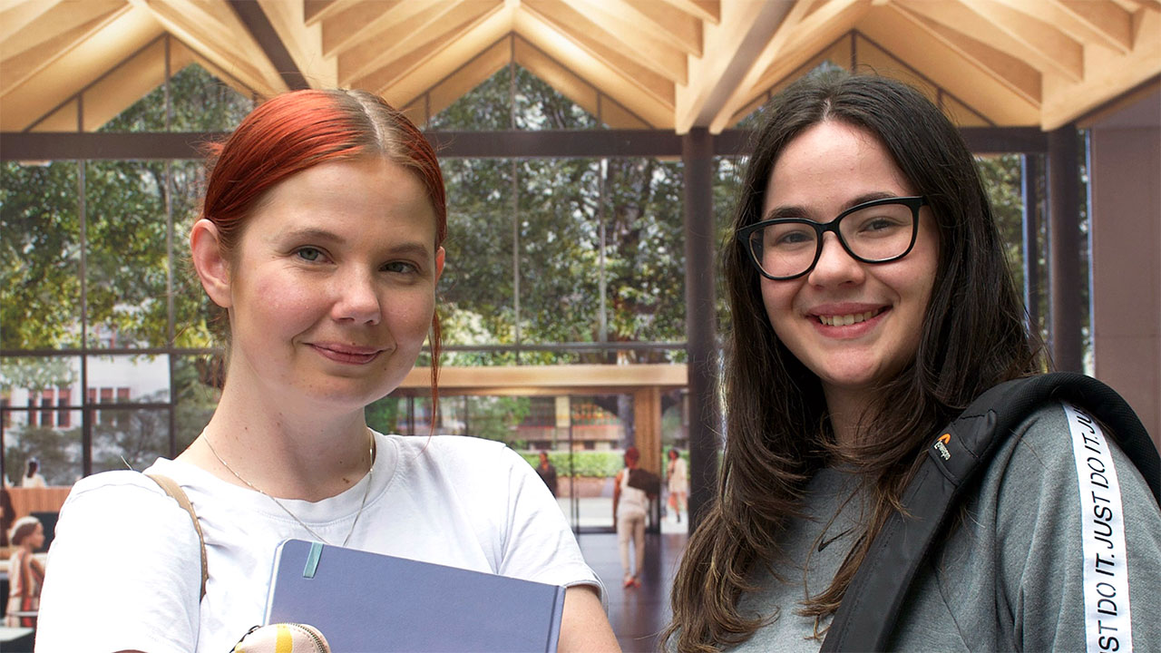 Two students smiling at the camera