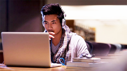A student looking at a laptop