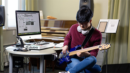 Student playing a guitar