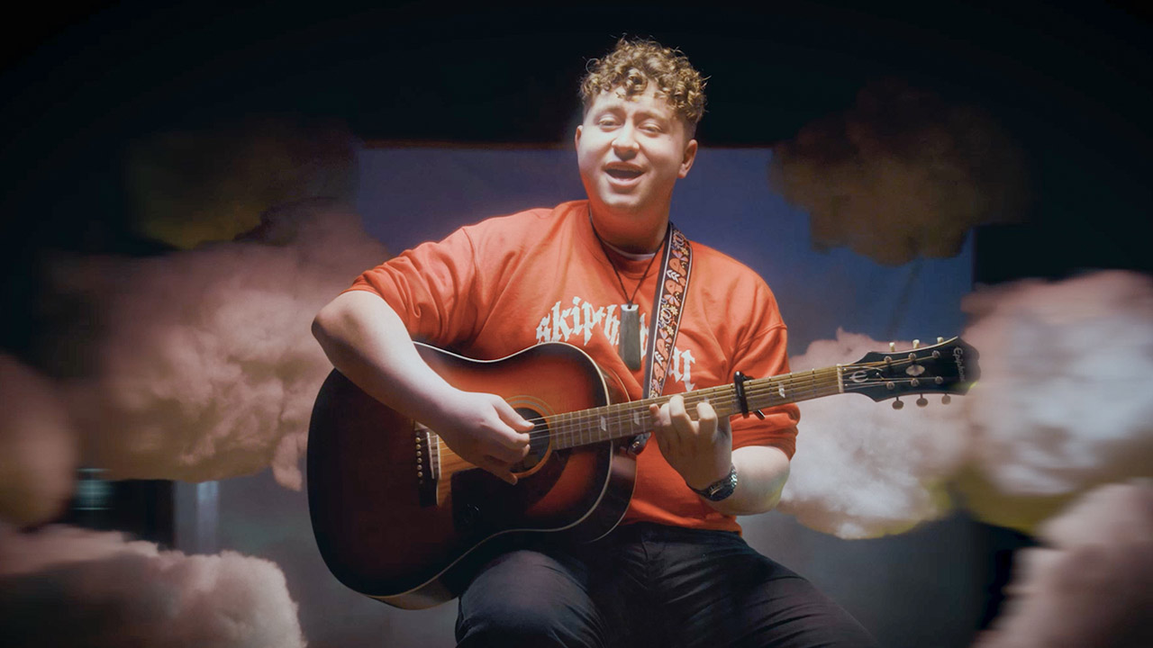 Young man playing a guitar.
