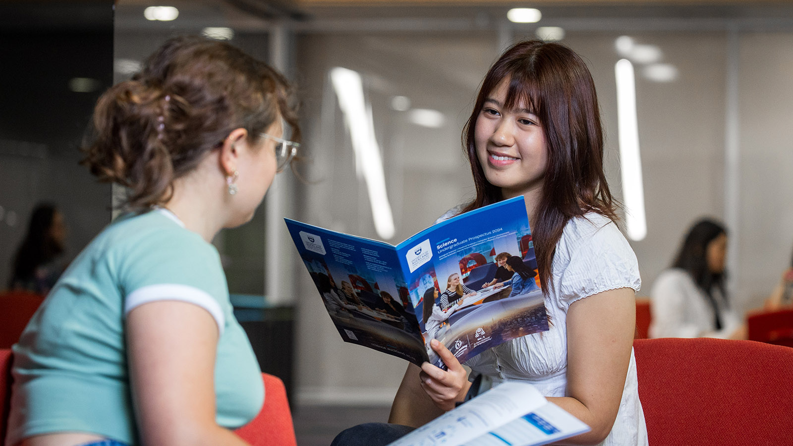 Two students reading the Science Prospectus.